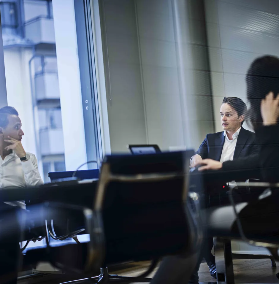 Two professionals in a meeting room.