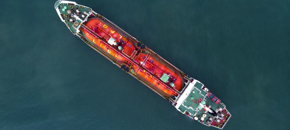 Aerial view of a large cargo ship on water.